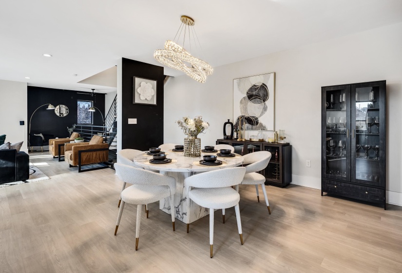 Dining area featuring stairway, light wood-type flooring, recessed lighting, and a chandelier