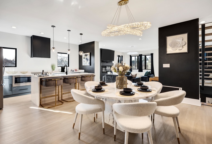 Dining room featuring light wood-style flooring, plenty of natural light, recessed lighting, and a chandelier