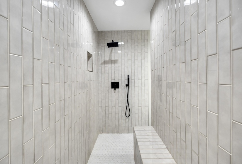 Bathroom featuring tiled shower and recessed lighting