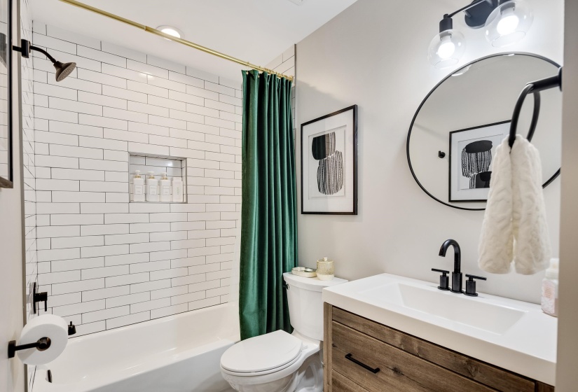 Bathroom featuring vanity and shower / bath combination with curtain
