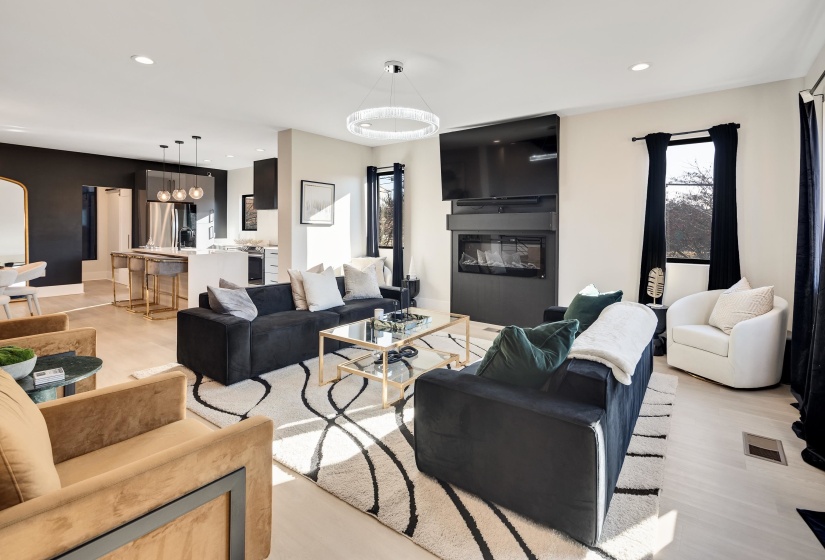 Living area with recessed lighting and a glass covered fireplace