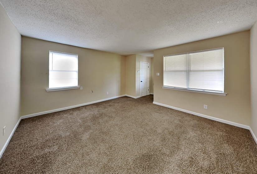 Carpeted spare room featuring a textured ceiling