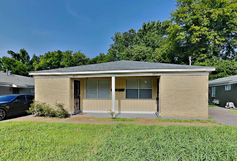 View of front of house featuring brick siding, a porch, a front lawn, and a shingled roof