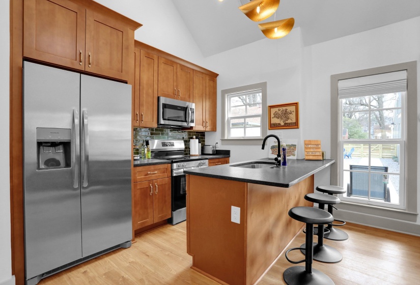 Kitchen featuring dark countertops, brown cabinets, a sink, and stainless steel appliances