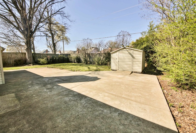 Fenced backyard with a storage shed
