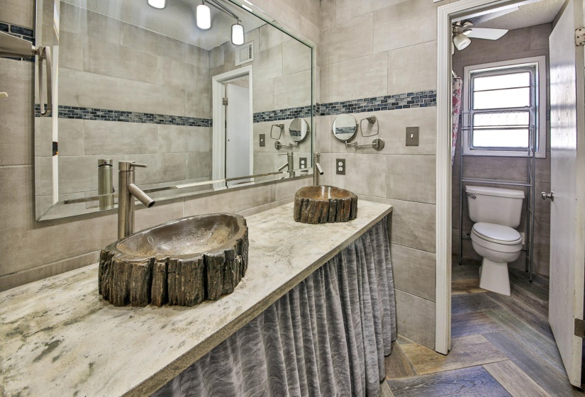 Bathroom featuring vanity, tile walls, parquet flooring, and ceiling fan