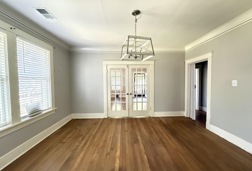 Unfurnished dining area with french doors and dark wood finished floors