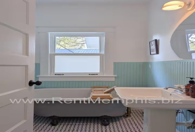 Full bath with a freestanding bath and wainscoting