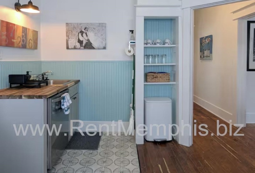 Bathroom with vanity, dark wood-type flooring, wainscoting, and built in features