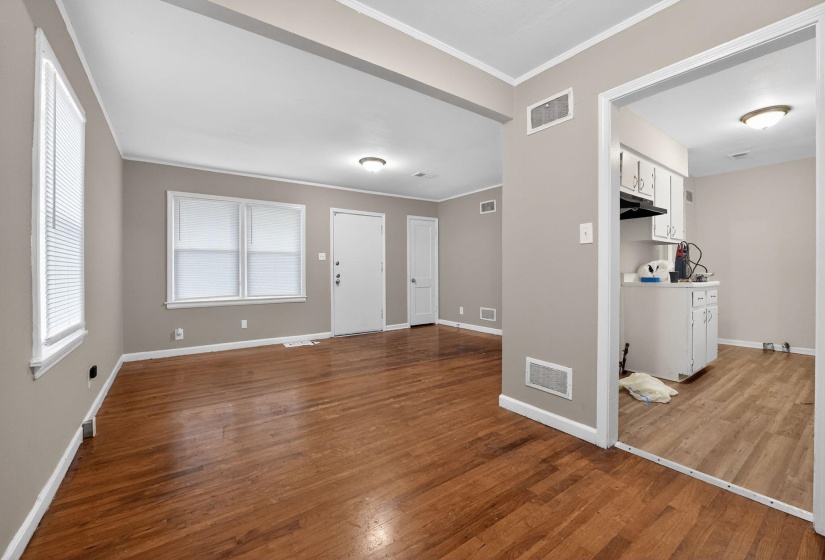 Entrance foyer featuring crown molding and light wood-type flooring