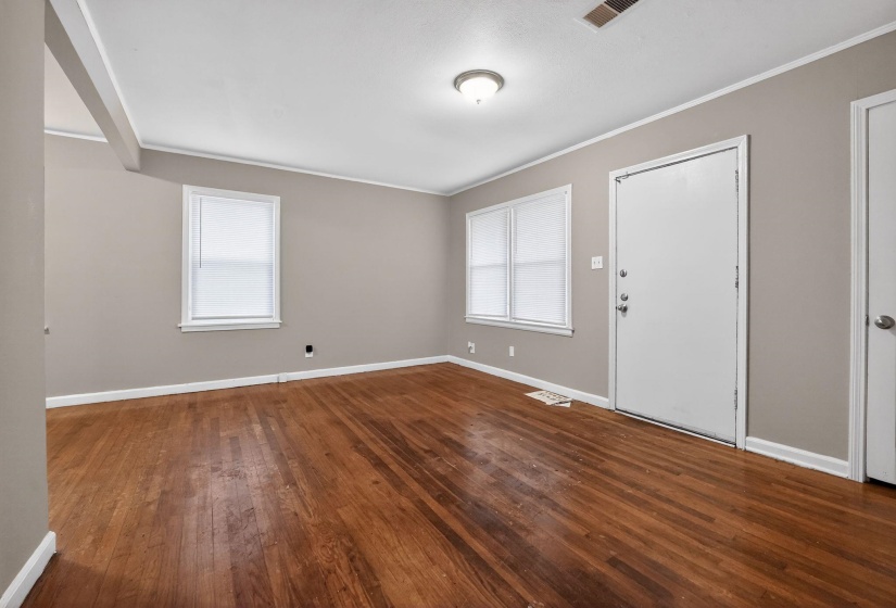 Entryway featuring baseboards and dark wood-type flooring