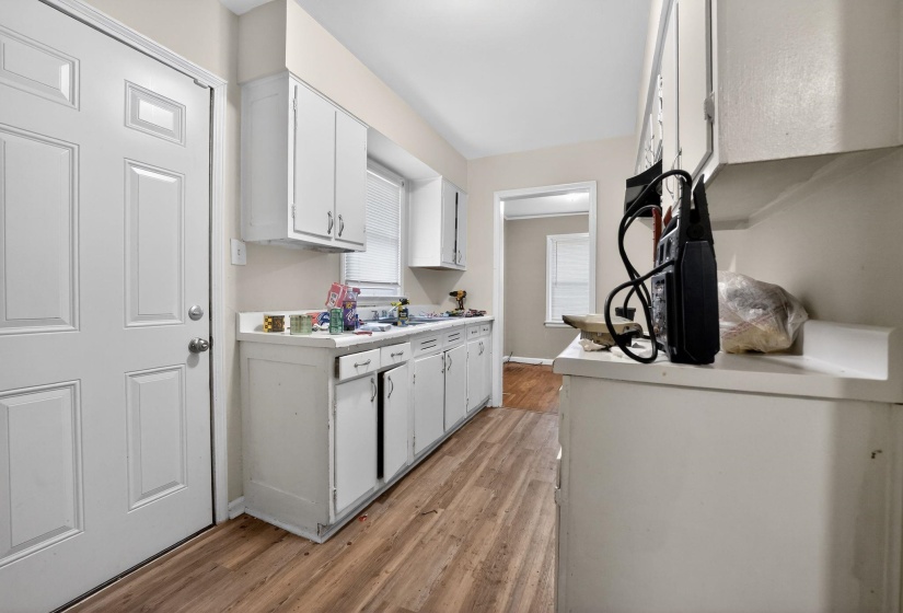 Kitchen featuring white cabinets, light countertops, and light wood-style floors