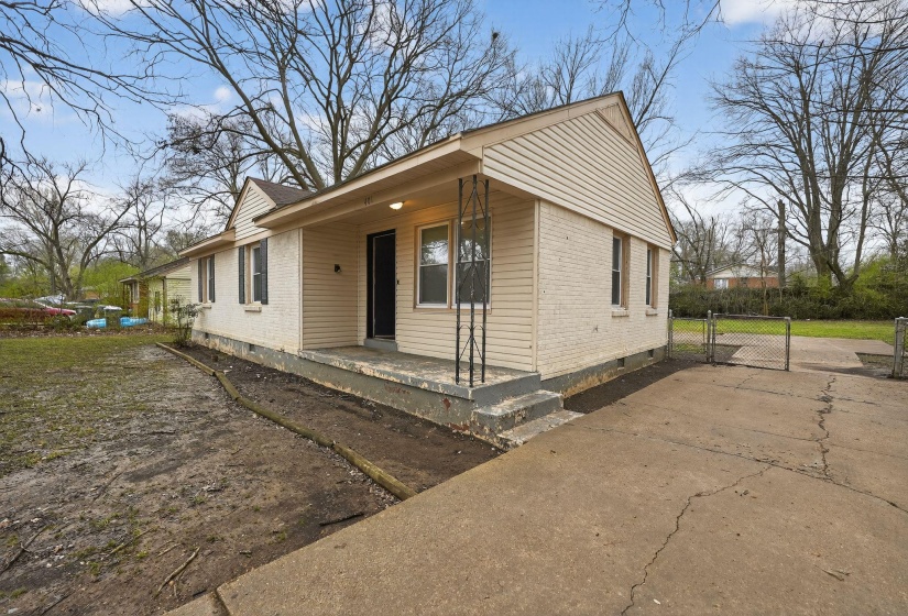 Bungalow-style home featuring a gate, brick siding, crawl space, and covered porch