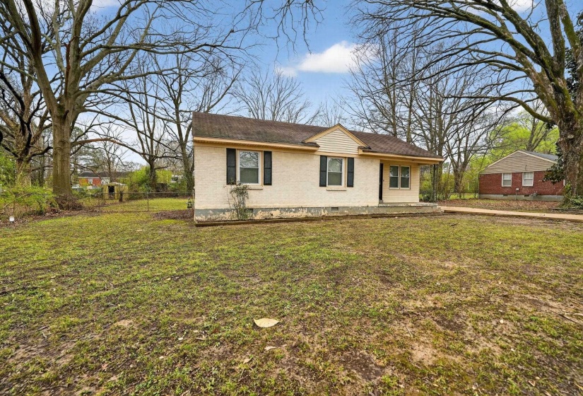 View of front of property with brick siding and roof with shingles