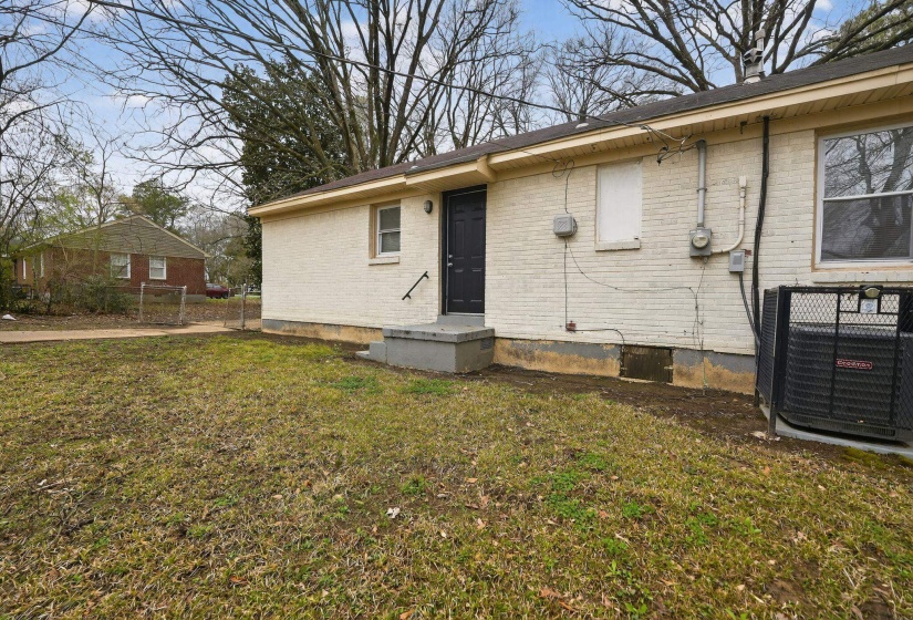 Rear view of house with brick siding