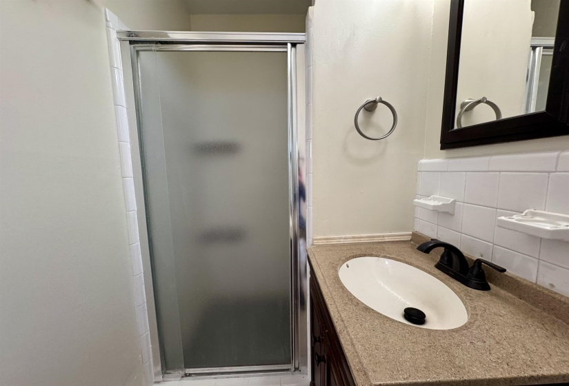 Full bathroom featuring vanity and a stall shower