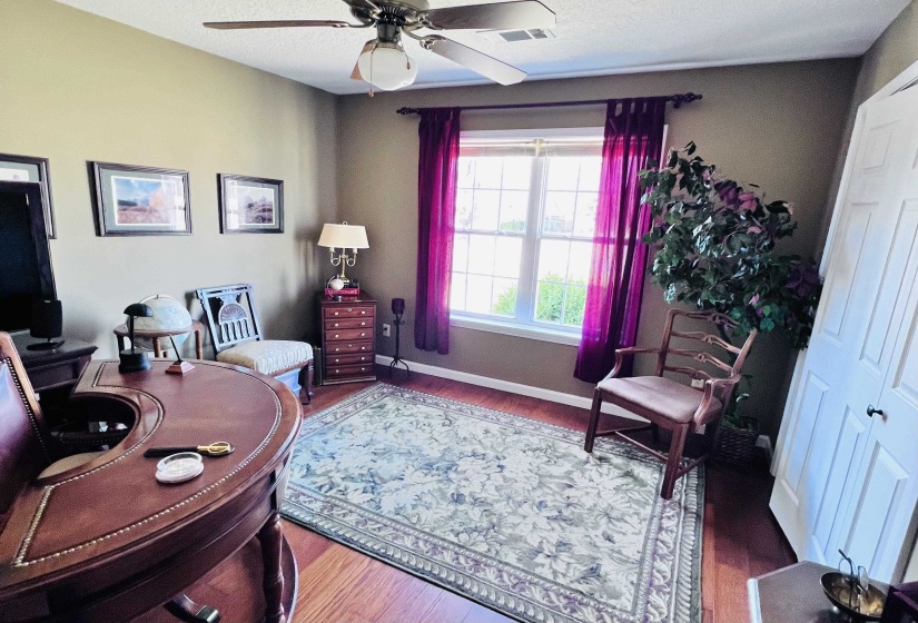 Office with a ceiling fan and wood finished floors