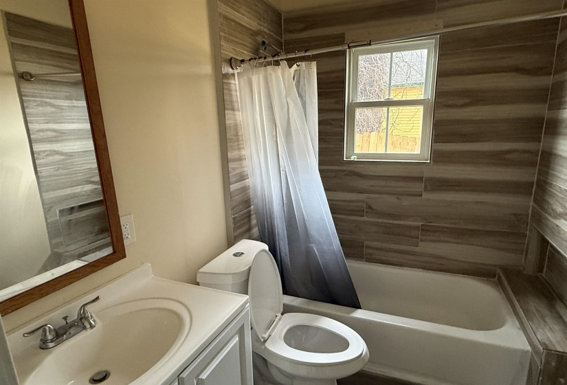 Full bath featuring vanity and shower / bath combo with shower curtain