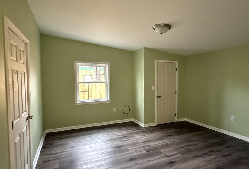 Spare room featuring dark wood-style floors