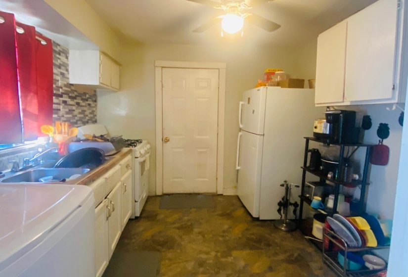 Kitchen featuring white cabinets, white appliances, tasteful backsplash, light countertops, and a ceiling fan