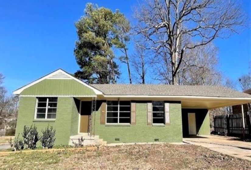 View of front of home featuring brick siding, crawl space, a carport, and concrete driveway