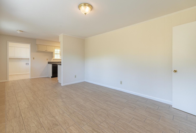 Unfurnished living room with baseboards