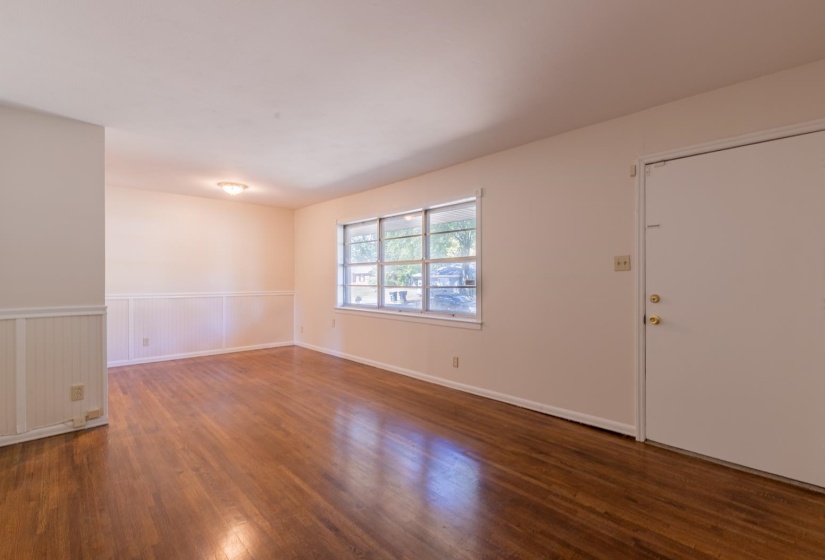 Spare room with wood finished floors and wainscoting