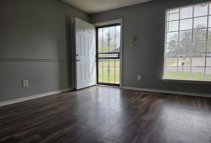 Unfurnished room featuring dark wood-style floors and a textured ceiling