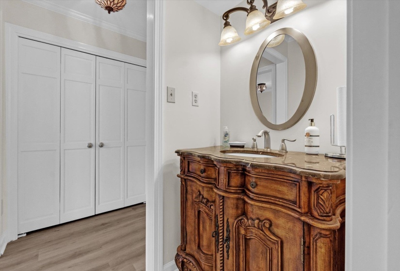 Bathroom with vanity, light wood-type flooring, and ornamental molding