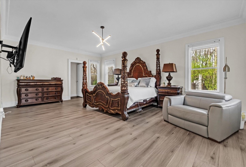 Bedroom featuring light wood-style flooring and ornamental molding
