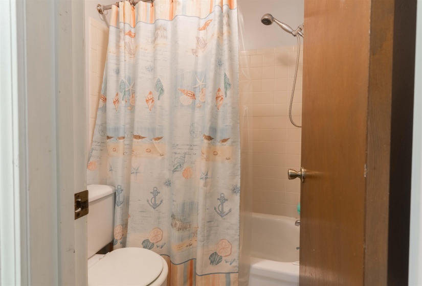 Bathroom with toilet and shower / tub combo