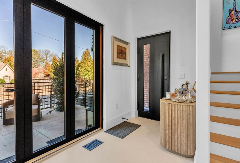 Doorway to outside with stairway and finished concrete floors