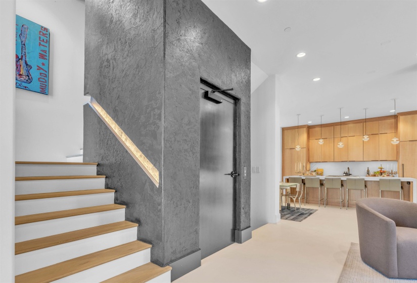 Stairs featuring a high ceiling, concrete floors, and recessed lighting