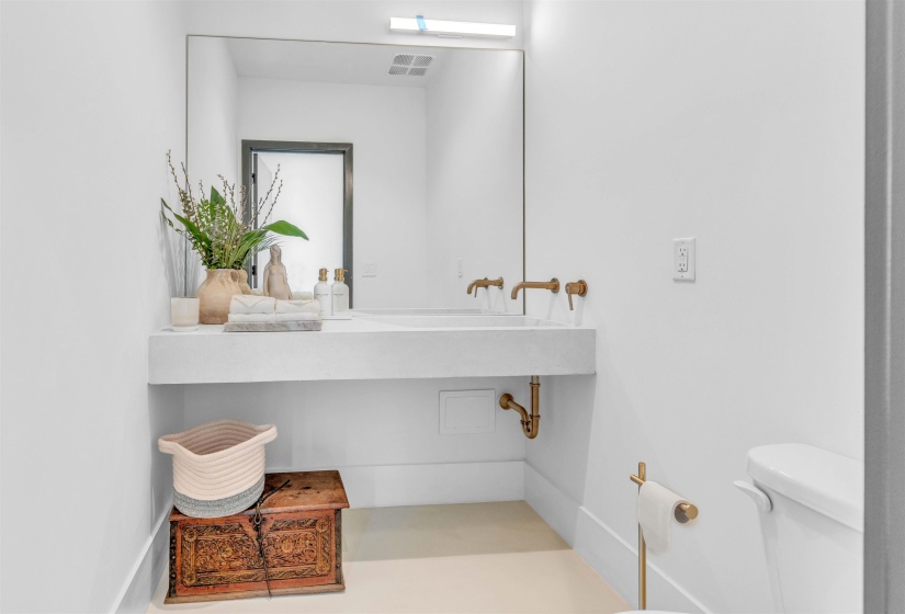 Half bathroom featuring toilet and vanity