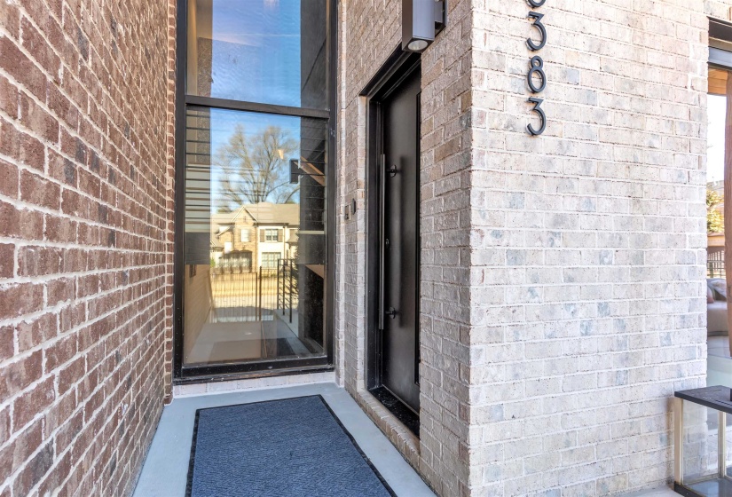 View of exterior entry featuring brick siding