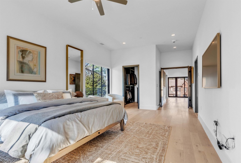 Bedroom featuring light wood-style floors, a spacious closet, recessed lighting, and a ceiling fan