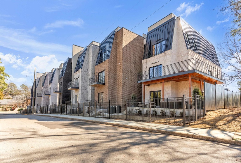View of apartment building / complex featuring a fenced front yard