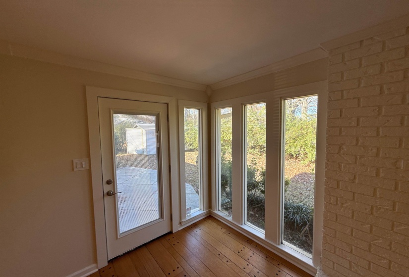 Entryway featuring wood-type flooring and ornamental molding