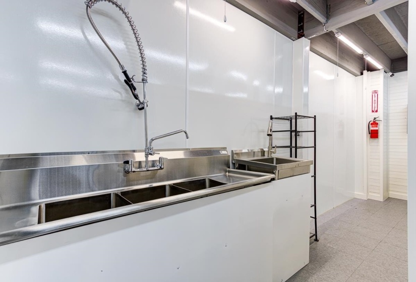 Kitchen with stainless steel countertops and white cabinetry