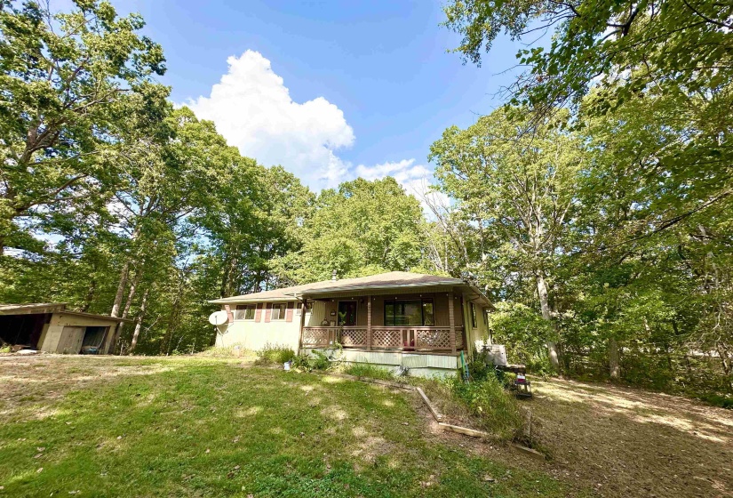 View of front of property featuring a porch and a front yard