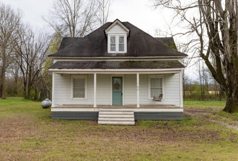 View of front of property featuring a porch and a front lawn