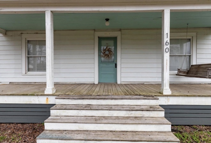 View of exterior entry with covered porch