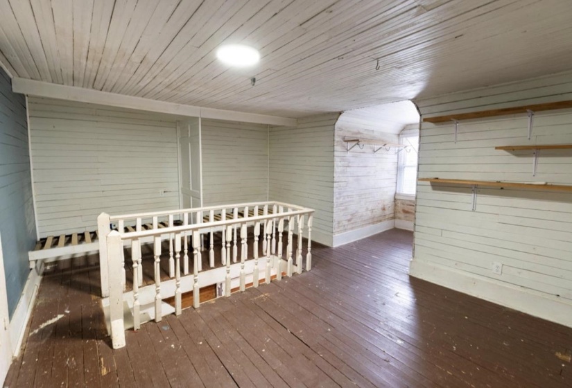 Bonus room with hardwood / wood-style flooring, wood walls, and wood ceiling