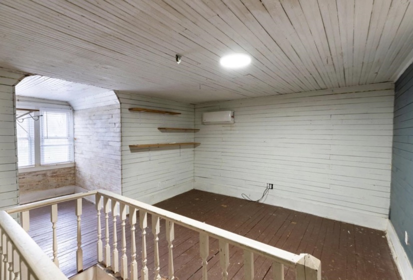 Interior space with hardwood / wood-style floors, wooden walls, and wooden ceiling