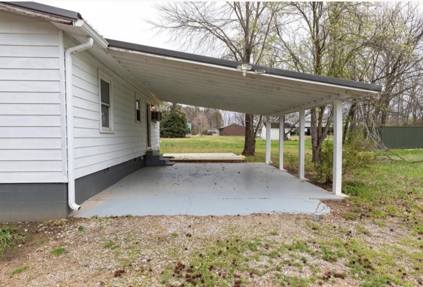 View of parking with a carport