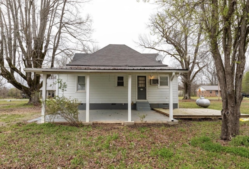 View of front of property with crawl space, a front yard, and covered porch