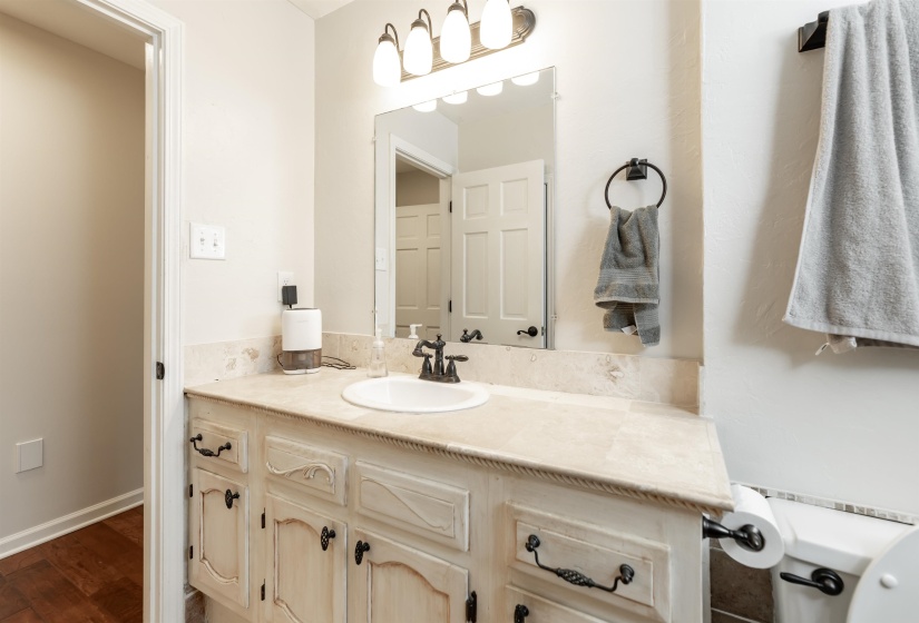 Bathroom featuring vanity and dark wood-type flooring