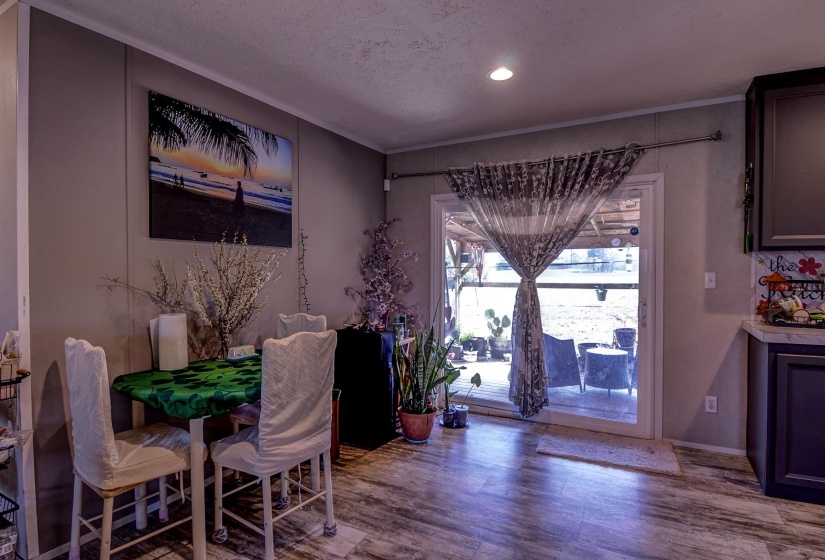 Dining area with wood finished floors and recessed lighting