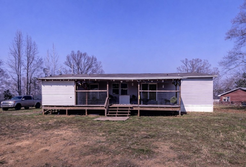 View of front of property with a front lawn and a deck
