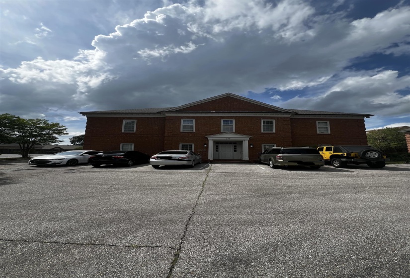View of property exterior with uncovered parking